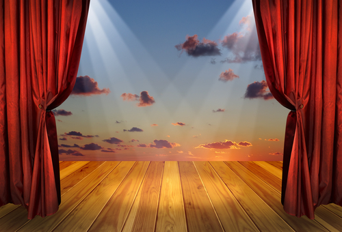Theater stage with red curtains and spotlights on the stage wooden floor. Theatre interior with decorations of the dramatic sky wallpaper.